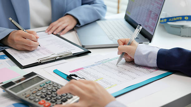 Expert woman asian female people review data number costing managerial account prepare monthly actual cost variance report income tax at audit office. ESG budget control ERP process service project.