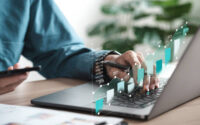 Businessman analyzing digital financial balance sheet of company working with digital virtual graphic design. Calculating long-term investment financial data icon on touch screen