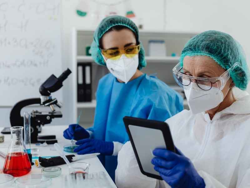 Researchers working in a laboratory setting to illustrate disease monitoring, biosecurity protocols, and health management in poultry systems.