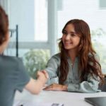 Business handshake across a desk representing opportunity, mutual respect, and professional growth in a modern office setting.
