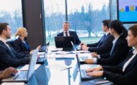 Corporate board members reviewing information during a governance meeting.