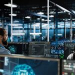 ybersecurity professionals monitoring digital systems in a business environment.