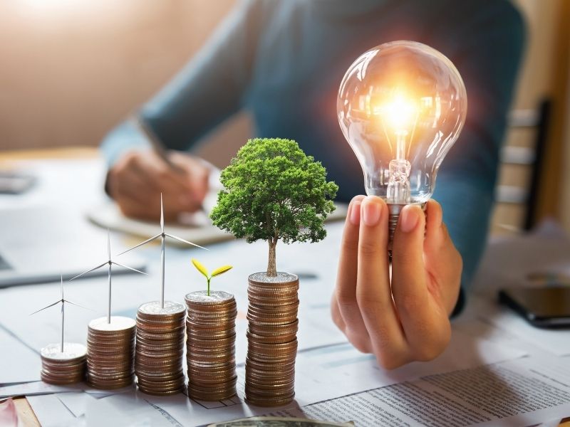 Sustainable finance targets represented through financial data and renewable energy investment projects.